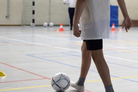 Enfant dans une salle de sport avec un ballon